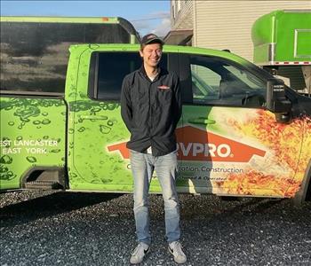 Tyler standing in front of servpro van